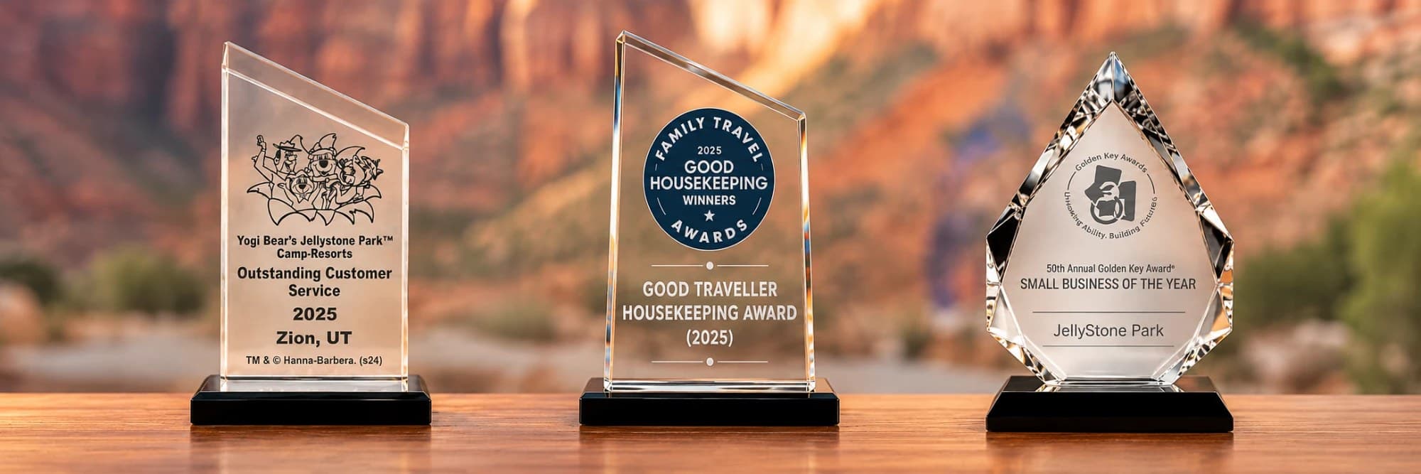 The park's 2025 Outstanding Customer Service, Good Traveller Housekeeping and Golden Key Small Business of the Year awards in front of the red rock