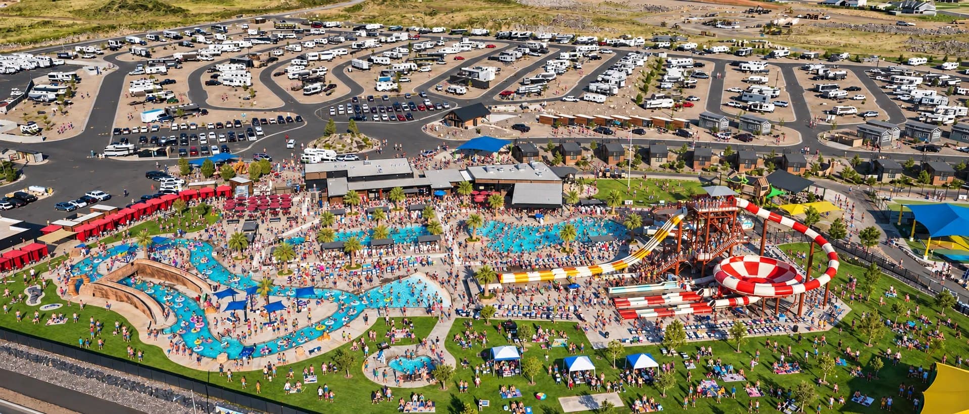 Aerial of the Jellystone Park Zion water zone on a busy summer day, with RV sites and cabins beyond