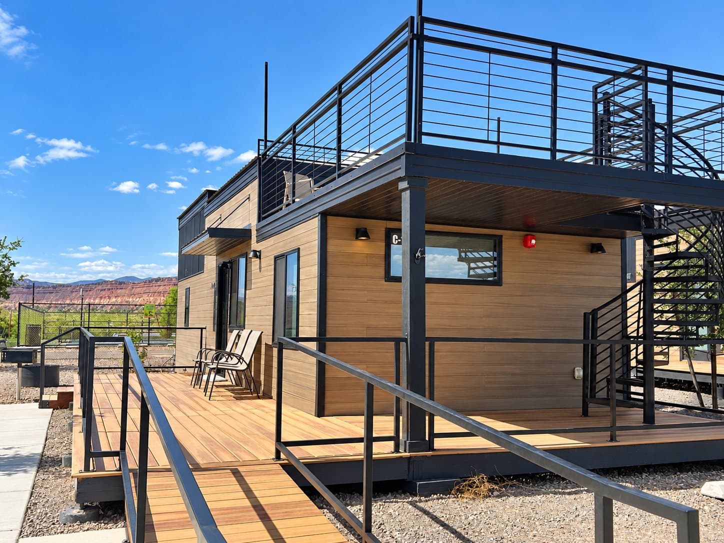 A two-story cabin with a rooftop deck