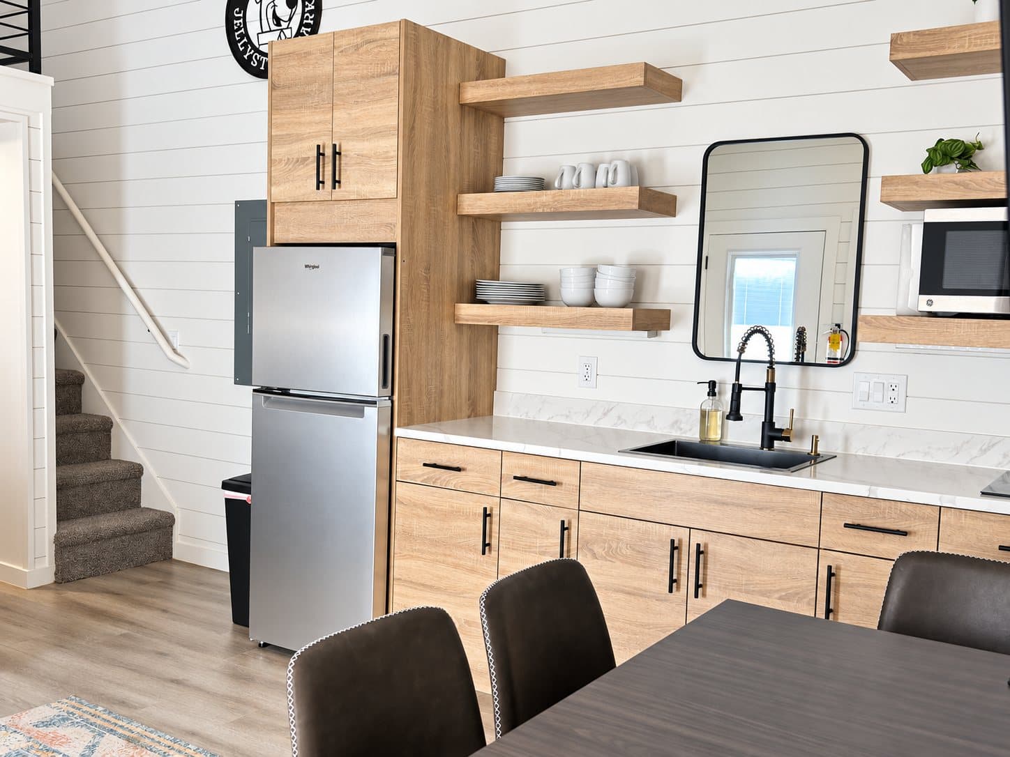 Cabin kitchen with stainless appliances and open shelving
