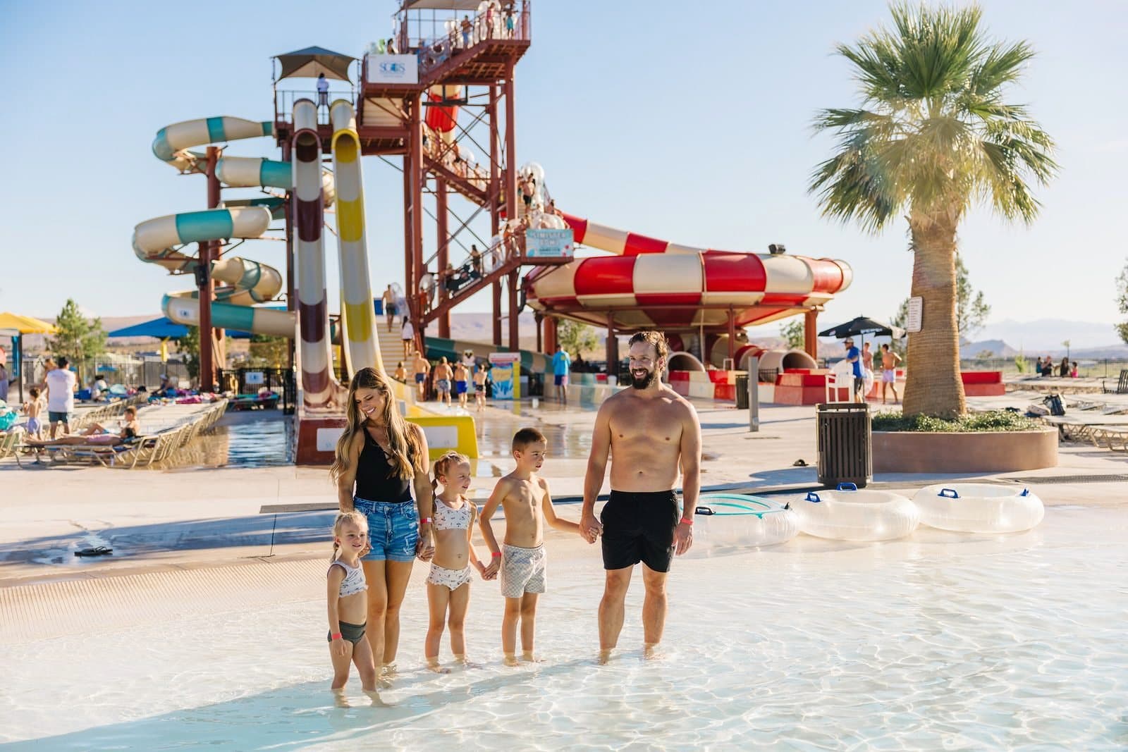 A family in the splash zone below the slide tower