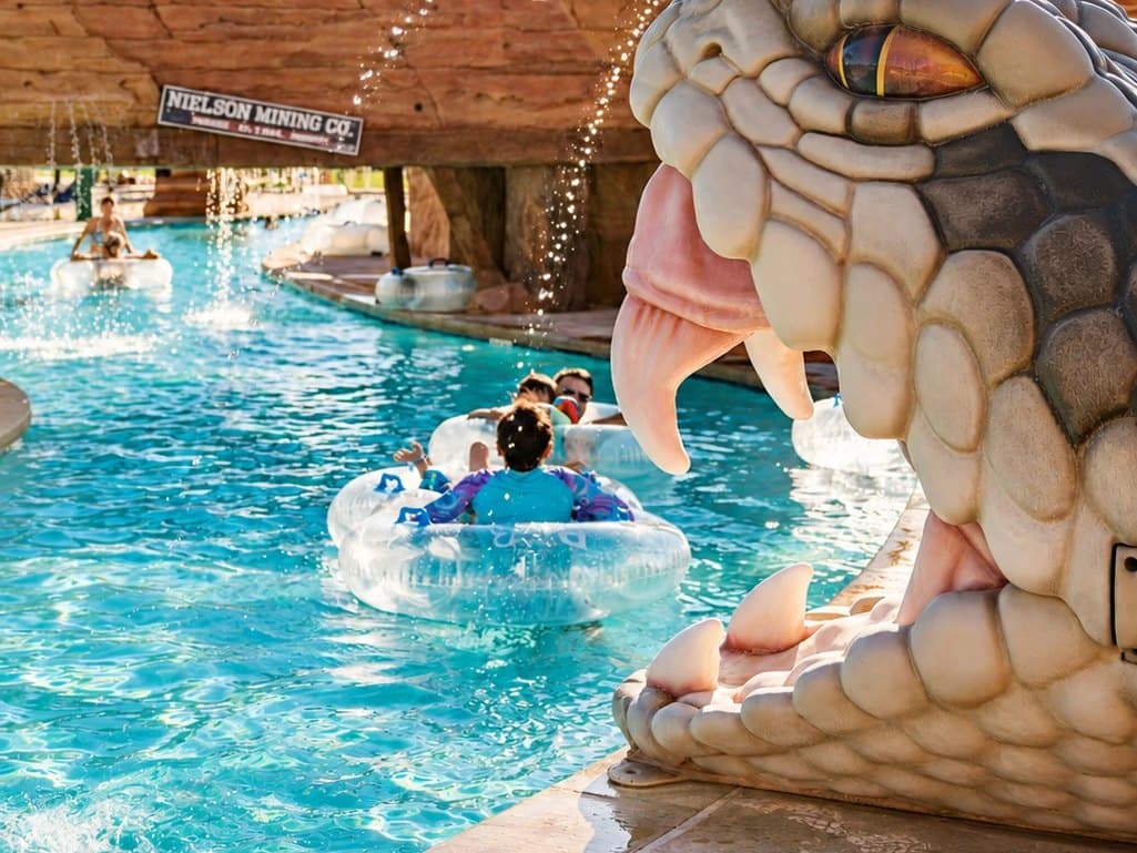 Families float the lazy river past the giant snake head and the Nielson Mining Co. bridge