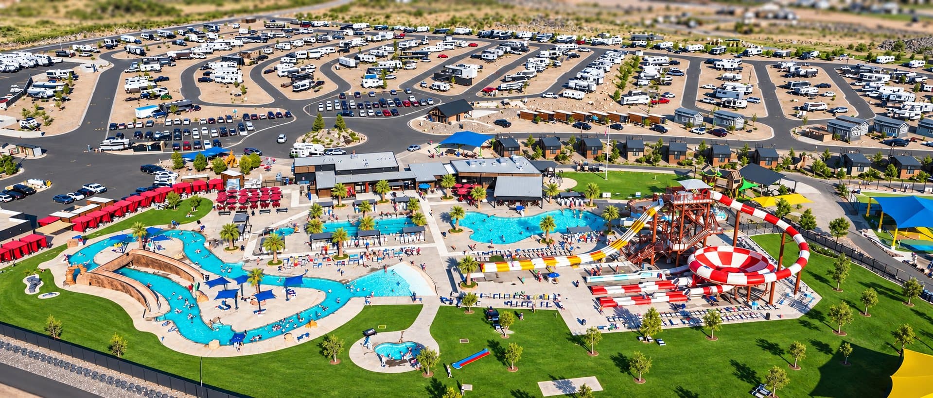 Aerial view of Jellystone Park Zion: the water zone, lazy river and rows of RV sites with red rock beyond